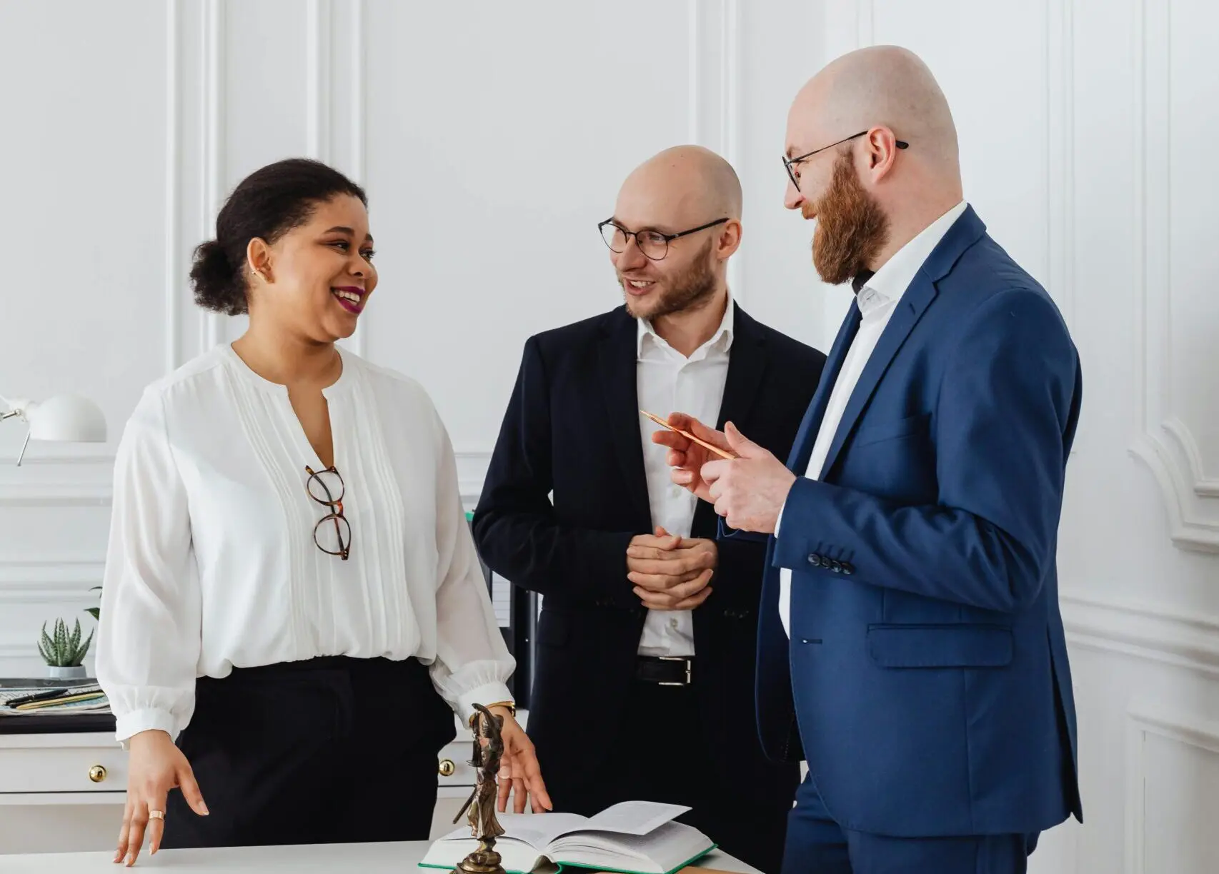 Three business workers having a discussion.